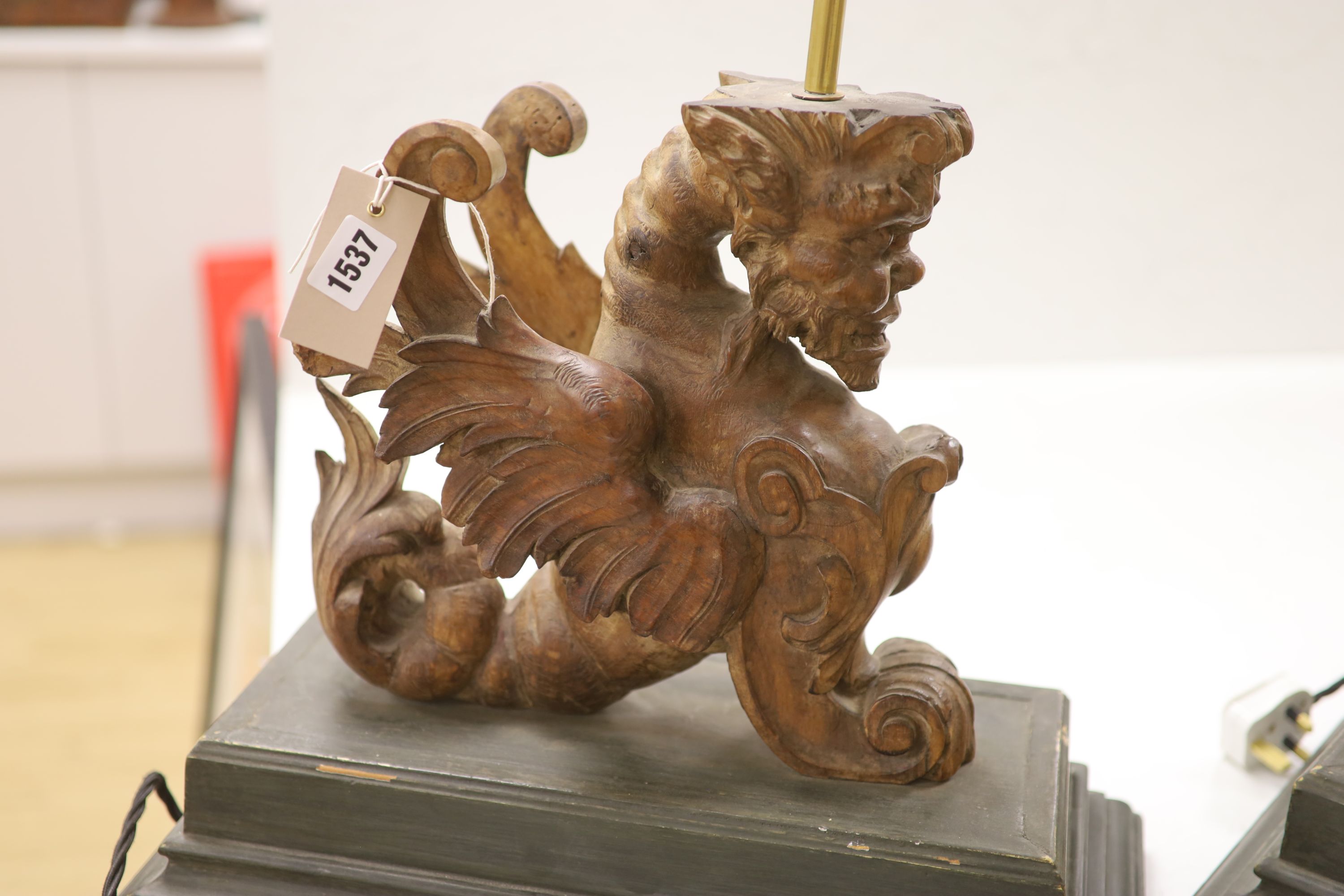 A pair of carved walnut winged griffin table lamps, 40cm high excl. light fitting